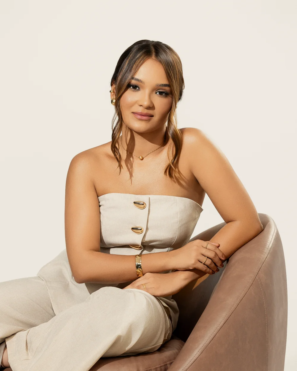 Bianca Lima sentada em uma poltrona